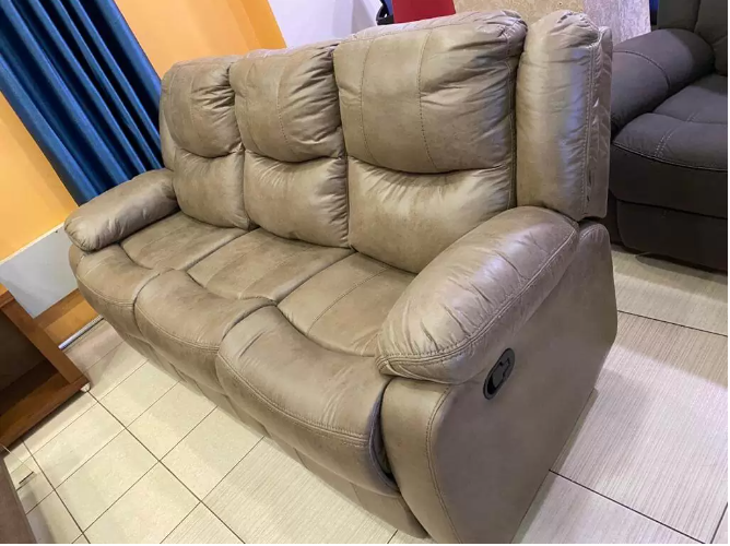 Large 3-seater soft leather recliner sofa with a promotional coffee table offer.